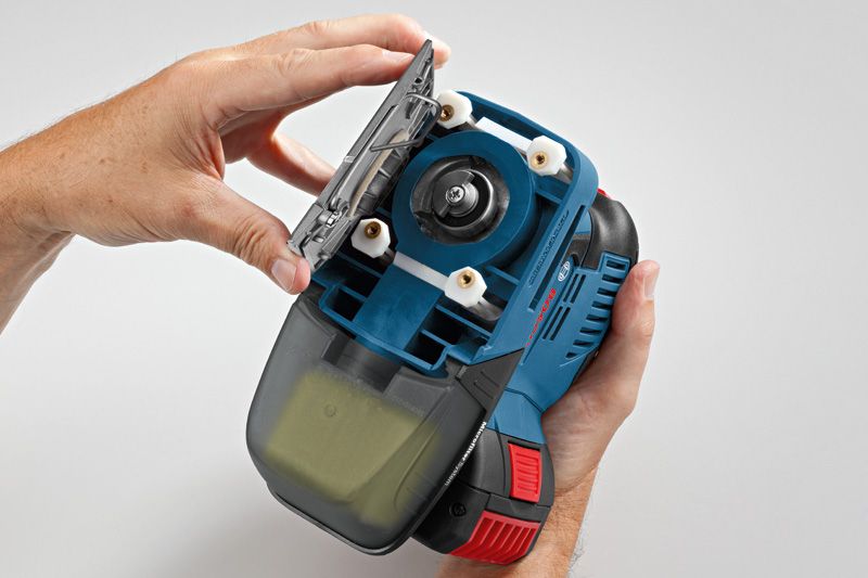Person changing the sanding pad on a cordless orbital sander.