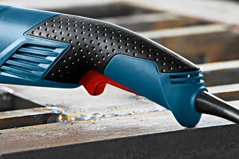 GWS 18-125 L Close-up of a textured ergonomic power tool handle with a visible trigger.