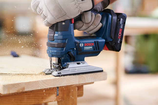 Jigsaw blade T 144 D Person wearing safety equipment uses a cordless jigsaw to cut wood.