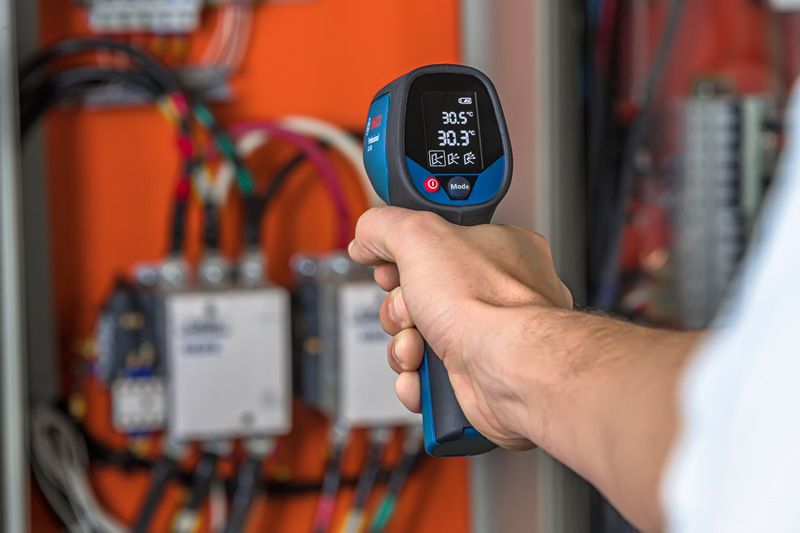 Infrared thermometer checks panel.