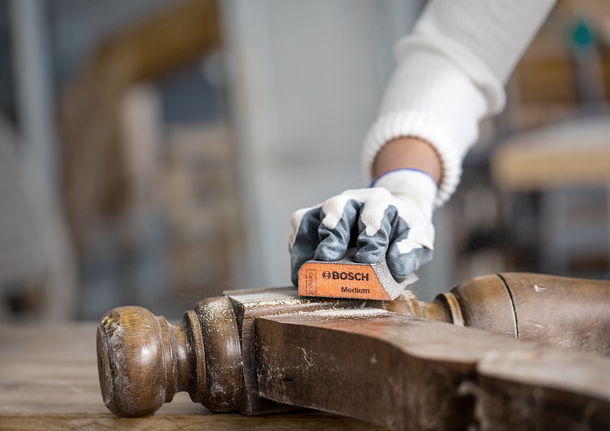 Bosch medium sanding sponge used on wood surface.