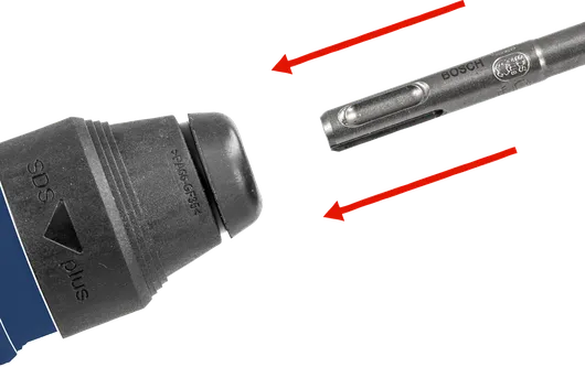 Drill bit being aligned with a tool chuck for attachment.