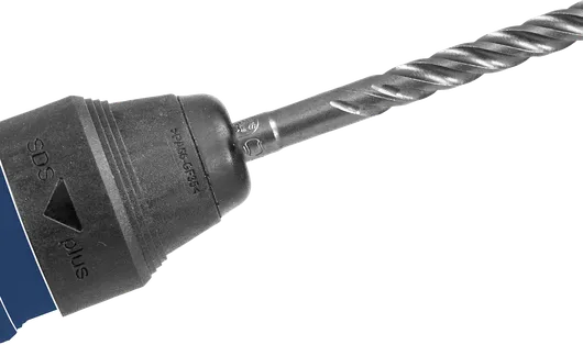 Close-up of a drill with a spiral bit attached for heavy-duty material drilling.