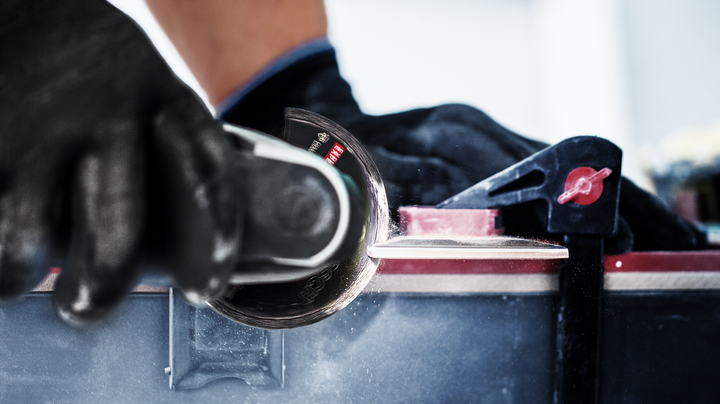 Object #200360604: 2793207_web_004 Worker wearing safety equipment cuts a hard panel with a circular saw blade.