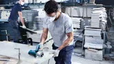Bosch GDC 140 diamond tile cutter in use on stone slab.