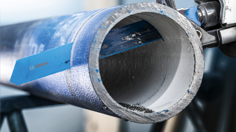 EXPERT ‘Cement Cast Iron’ S 1750 RD Reciprocating Saw Blade 1-pc Saw blade cutting through a thick metal pipe in an industrial setting.