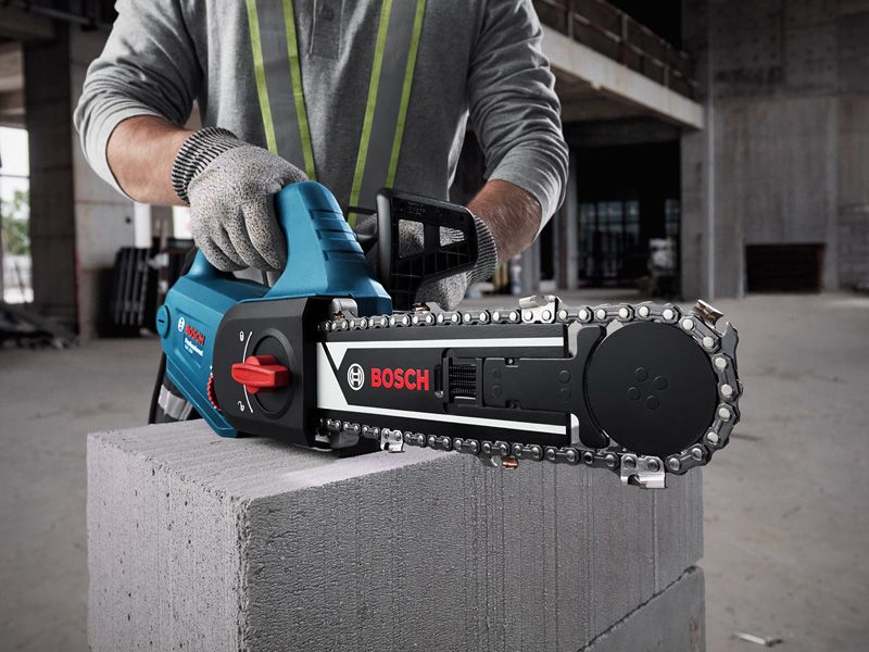 GAC 250 A person wearing safety equipment uses an AAC block cutter on a concrete block.