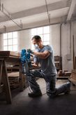 Bosch GBS 750 belt sander used for wood surface sanding.
