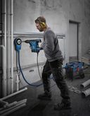 Bosch GBH 6-42 C rotary hammer drilling into a wall.