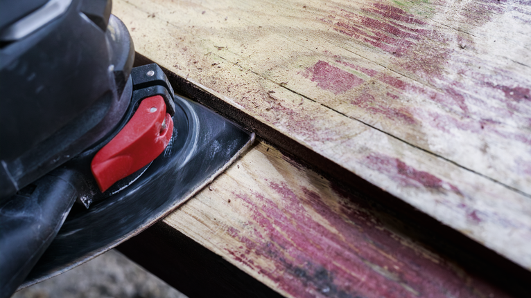 PRO AVZ 93 G Multitool Accessory, 93 mm Electric sander smoothing a weathered wooden plank.
