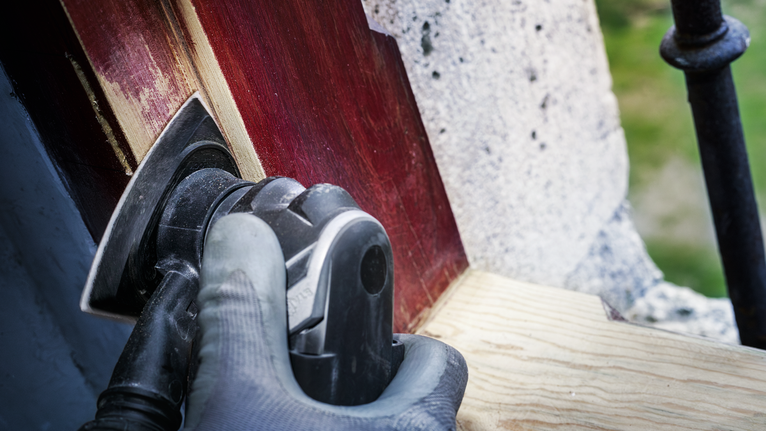 PRO AVZ 93 G Multitool Accessory, 93 mm Person wearing safety equipment sanding painted wood with a power tool.