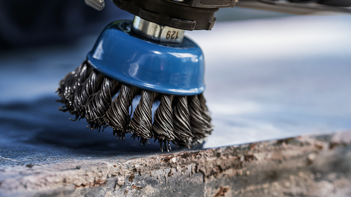Object #200456905: 3089943_app_web_02 Wire brush attachment cleaning rust from a metal surface.