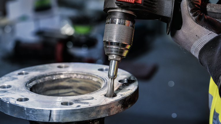 PRO Metal clean End Brush, Straight Shank, 25 x 0.3 mm Person wearing safety equipment uses a power tool to polish the inside of a metal flange.