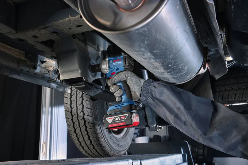GDS 18V-350 + GSB 185 Combo A person wearing safety equipment tightens a bolt on a car undercarriage with a cordless impact wrench.