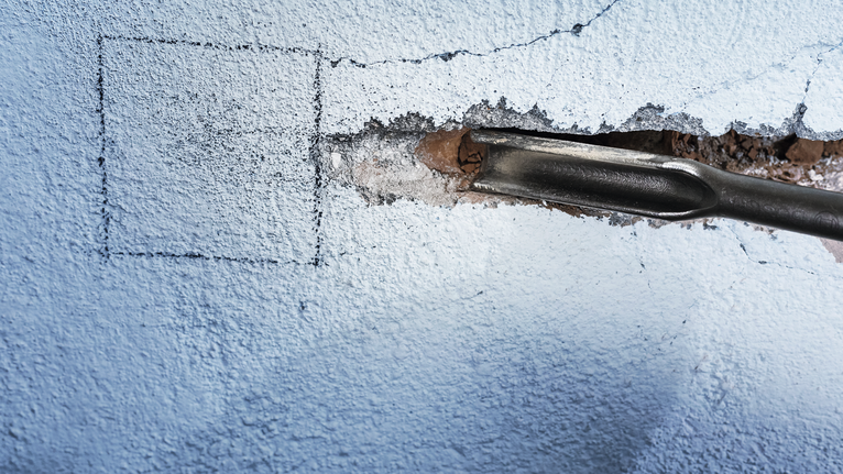 PRO SDS max Hollow Gouging Chisel, 26 x 300 mm Chisel tool creating a groove in a concrete wall.