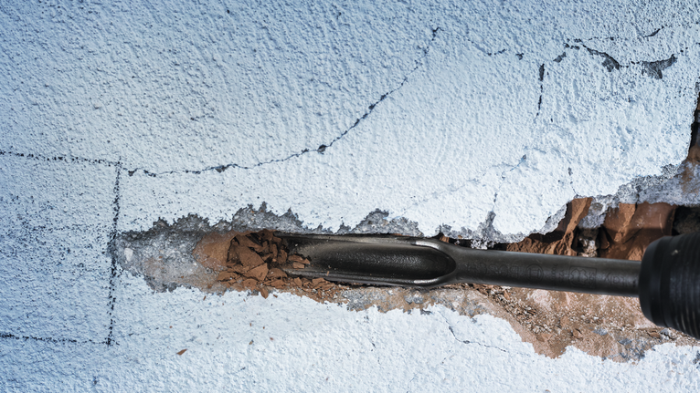 PRO SDS max Hollow Gouging Chisel, 26 x 300 mm Chisel demolishing a cracked concrete wall.