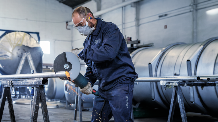 PRO Stainless Steel and Metal Bonded Cutting Disc, 230 x 1.9 x 22.23 mm, Straight A person wearing safety equipment grinds a metal pipe, creating sparks.