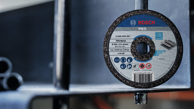 PRO Metal Cutting Disc, 100 x 2.5 x 16 mm Grinding disc attached to a metal structure in an industrial setting.