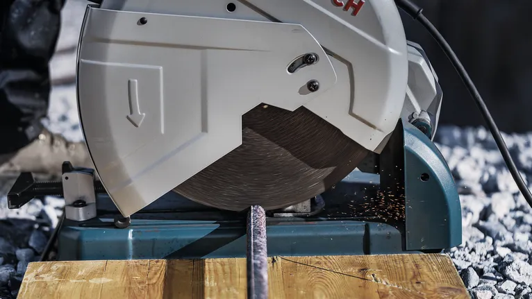 PRO Metal Cutting Disc, 355 x 3 x 25.4 mm Metal cutting saw slicing through a rebar, producing sparks on a wooden surface.