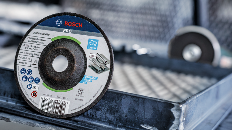 Cutting disc with product labels displayed, resting on a metal surface.