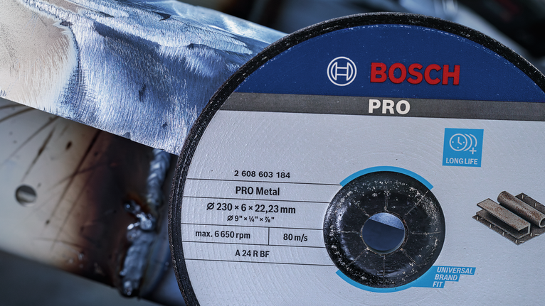 PRO Stainless Steel Grinding Disc, 100 x 6 x 16 mm Cutting disc positioned near a metal pipe for grinding or cutting work.