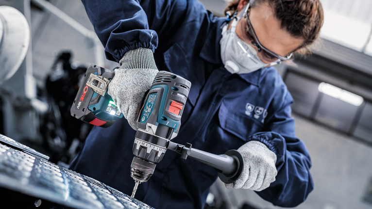 PRO Metal HSS-G Hex Twist Drill Bit Set, 5 pcs Person wearing safety equipment drills into metal using a power tool.