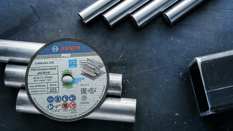 PRO Stainless Steel and Metal Bonded Cutting Disc, 76 x 1 x 10 mm Cutting disc resting on metal pipes on a workshop table.