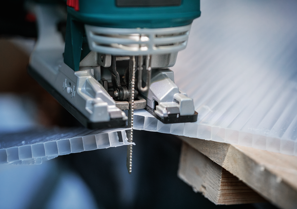 Bosch jigsaw blade cutting corrugated plastic sheet.
