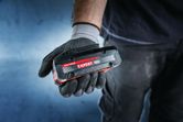 Bosch Expert 18V battery held in a gloved hand.