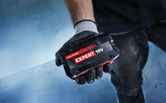 Bosch Expert 18V battery held in a gloved hand.