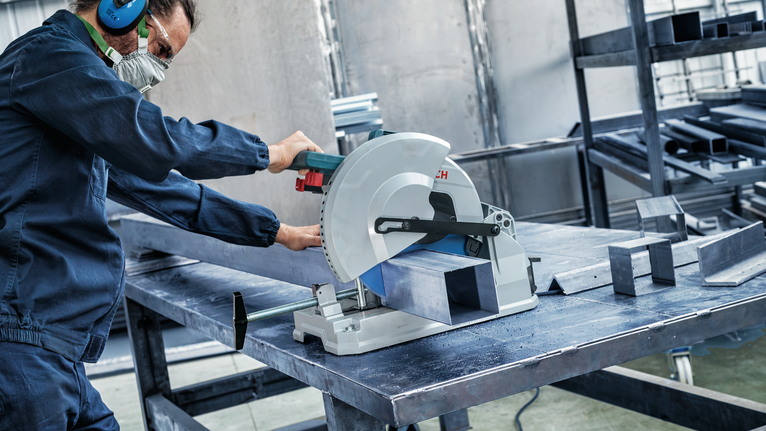 EXPERT Steel Circular Saw Blade, 305 x 2.6/2.2 x 25.4 mm, T60 Person wearing safety equipment cuts a metal beam with a circular saw in a workshop.